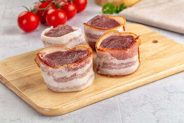 Raw pork tenferloin with bacon