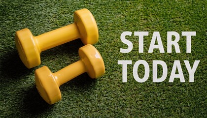 Two yellow dumbbells on green grass, symbolizing a fresh start to fitness journey.