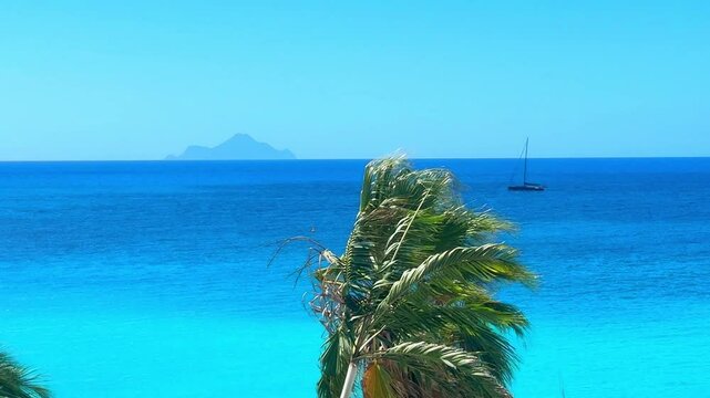 Clear blue water of Caribbean sea in St. Martin island with a sunning view of Saba island on horizon. Boat is cruising, tropical atmosphere is peaceful and relaxing