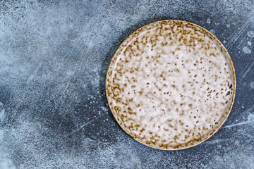 Ceramic plate mottled pattern on grey background