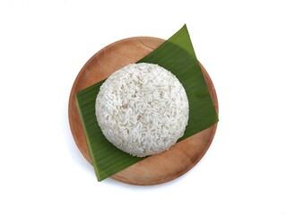 White rice on wooden plate with banana leaf isolated on white background, Top view 
