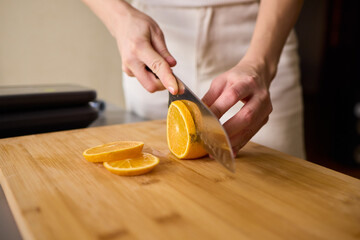 Slicing Fresh Oranges on a Beautiful Wooden Cutting Board to Enhance Your Culinary Skills