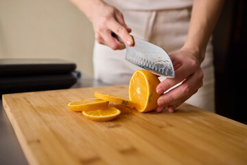 Slicing Fresh Oranges on a Beautiful Wooden Cutting Board to Enhance Your Culinary Skills