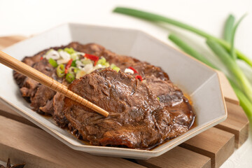 Taiwanese braised beef shank slices in a plate on white table background.
