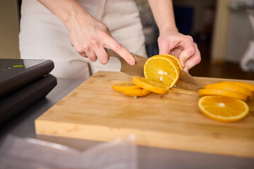 Slicing Fresh Oranges on a Beautiful Wooden Cutting Board to Enhance Your Culinary Skills