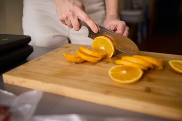 Slicing Fresh Oranges on a Beautiful Wooden Cutting Board to Enhance Your Culinary Skills