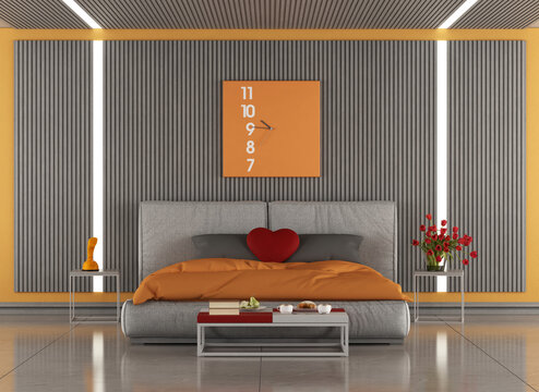 Modern master bedroom interior with orange and gray design featuring comfortable bed