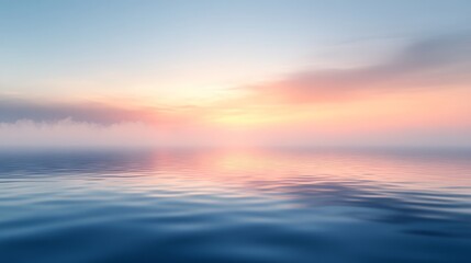 Obraz premium Stunning sunset view over calm ocean waters with fog and clouds on the horizon