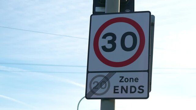 Speed limit sign of 30 zone in United Kingdom. Traffic regulation board with thirty restriction area in Britain. Road safety indicator displaying maximum velocity control in England