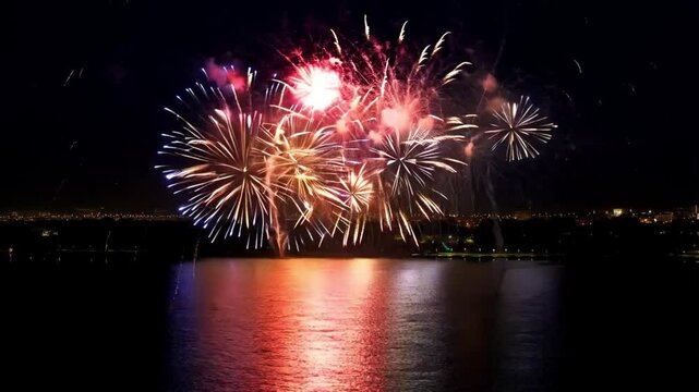 Colorful fireworks reflecting on the river during a night celebration