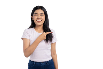 Obraz premium Happy young Asian woman pointing at copy space with a smile, feeling confident and cheerful, isolated on transparent background