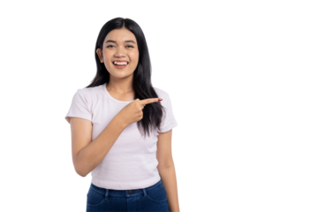 Happy young Asian woman pointing at copy space with a smile, feeling confident and cheerful, isolated on transparent background