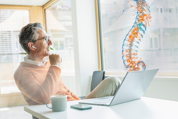 Man using augmented reality to analyze spine data in office