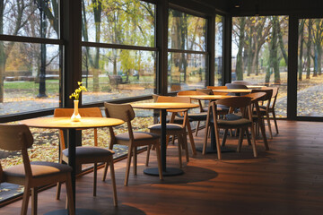 Stylish restaurant with large windows and comfortable furniture. Interior design