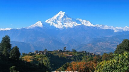 A majestic snow capped mountain rises above a rural village