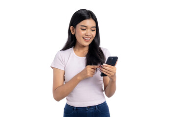 Happy young Asian woman smiling while using smartphone, pointing at screen, isolated on transparent...