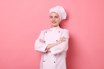 Portrait of confectioner in uniform on pink background