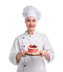 Happy confectioner in uniform holding delicious cake with berries on white background