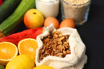 Various healthy fruits, vegetables and cereals on dark background. Selective focus.