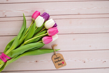 bouquet of tulips with a tag that says Happy Mothers Day