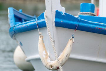 Bow detail of Greek traditional wooden boat with bumper and rope