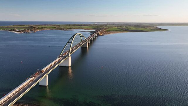 Aerial footage of Fehmarn Sound Bridge (Fehmarnsundbr&uuml;cke), suspension bridge with steel arches connecting the German mainland with the island in the Baltic Sea. Camera panning from left to right.