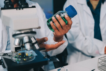 Team Asian scientists in a lab conducting food research using a microscope and lab equipment, showcasing innovation in food science and biotechnology