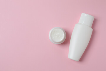 Natural cosmetic products on a pink background, top view
