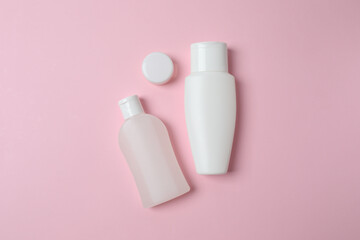 Natural cosmetic products on a pink background, top view