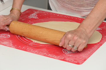 Rolling dough on a kitchen countertop while preparing for a delightful baking session with family...