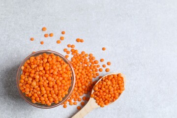 Red lentils in a jar on a gray background