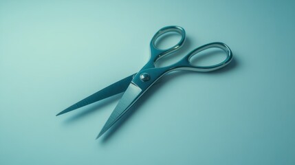 A pair of shiny metallic scissors laying on a smooth surface