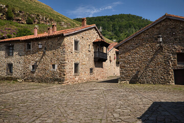 Typical house of Bárcena Mayor, type of house known as mountain house made of stone, masonry and wood. The arcades with ashlar arches and especially the wood carving with decoration on beams, pillars.