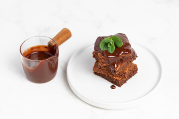 Pieces of chocolate brownies on a light background. Delicious and sweet homemade pastries for breakfast. Vegetarian dessert.
