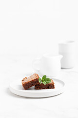 Pieces of chocolate brownies on a light background. Delicious and sweet homemade pastries for breakfast. Vegetarian dessert.
