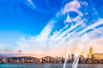 Fototapeta premium A creative double exposure technique merges a person's face with the iconic Hong Kong skyline, set against a backdrop of blue sky and ocean.