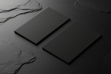 Two sleek, minimalistic black business cards positioned on a textured dark surface, showcasing an elegant design, ideal for professional networking or branding purposes