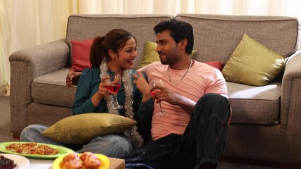 Couple enjoying the birthday and having snacks and wine together