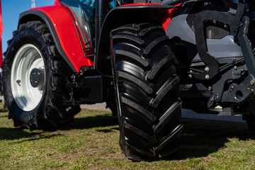 Massive industrial orange rim tractor tires. Tractor expo tyre close up
