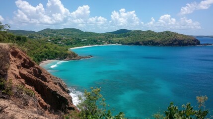 Obraz premium A scenic view from a beachside cliff, overlooking a cove with turquoise waters and soft waves.