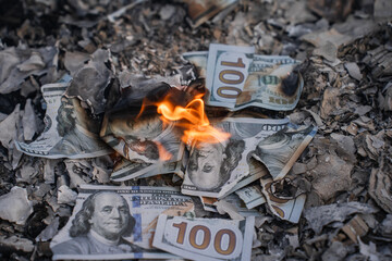 Burning US Dollar Bills on Ashes Representing Financial Loss and Waste