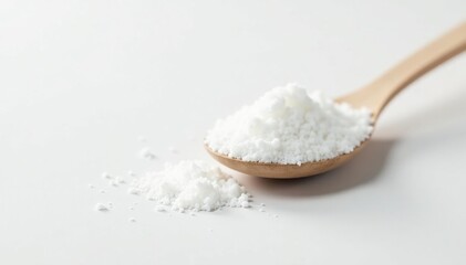 Spoonful of white sugar against white backdrop, culinary, minimal, pure