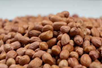 Peanut background, lots of raw peeled brown peanuts close-up.