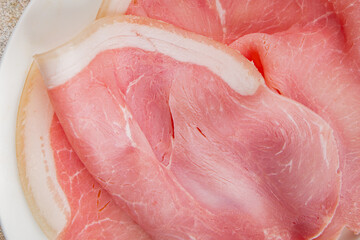 Ham slices pork meat tasty gourmet food background on the table rustic food top view copy space