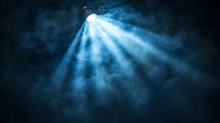 Blue spotlight beam cutting through smoke