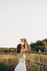 A Young Woman Surrounded by Beautiful, Vibrant Wildflowers in a Lush Meadow During the Golden Hour,...