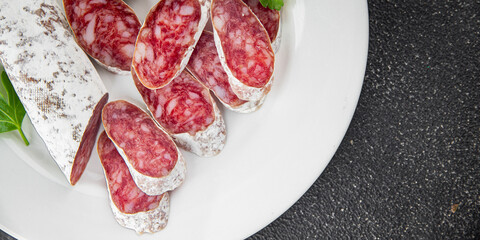 Fuet sausage meat Spanish delicacy gourmet food background on the table rustic food top view copy...