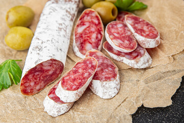 Fuet sausage meat Spanish delicacy gourmet food background on the table rustic food top view copy space