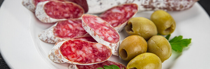 Obraz premium Fuet sausage meat Spanish delicacy gourmet food background on the table rustic food top view copy space