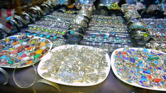 Rows of different jewelry with semiprecious stones at traditional middle eastern bazaar. Jewellery for sale at Khan El Khalili bazaar, Cairo, Egypt